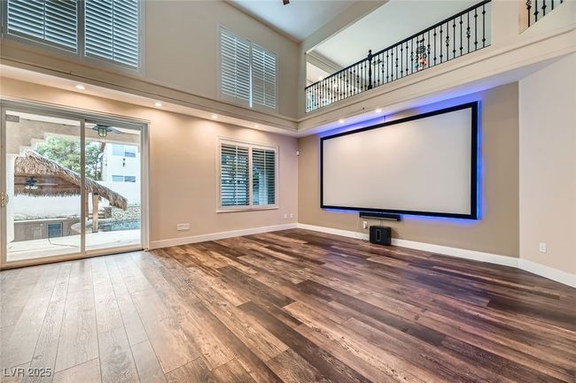 Cinema room with a high ceiling and wood finished floors | Image 16