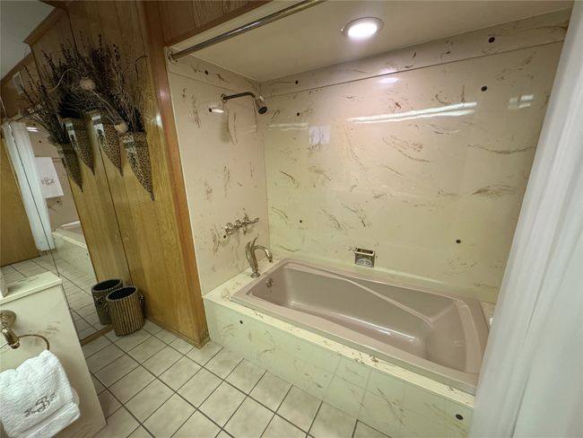 Full bathroom featuring tile patterned flooring and shower / tub combination | Image 36