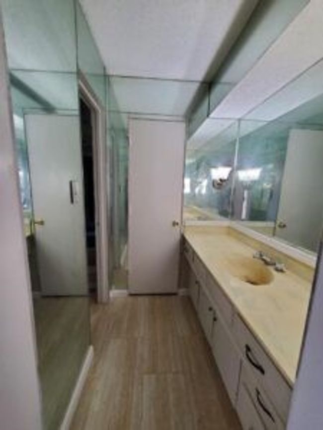 Bathroom with vanity, wood finished floors, and a stall shower | Image 29