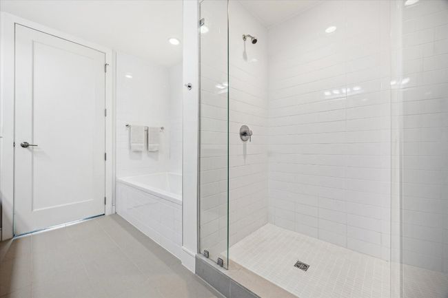 Bathroom featuring tile patterned flooring, a garden tub, and a stall shower | Image 9