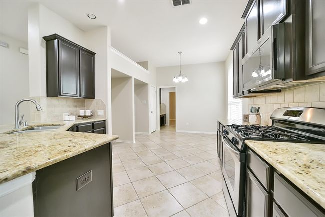 Stainless steel appliances compliment this kitchen's color scheme beautifully. | Image 8