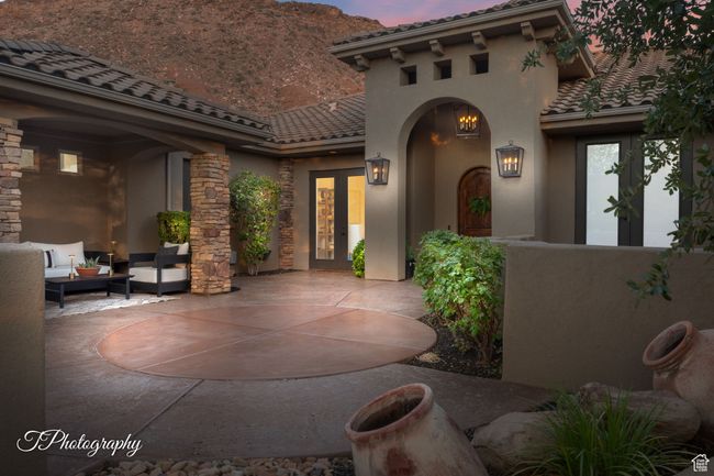 Patio terrace at dusk featuring french doors, a patio area, and outdoor lounge area | Image 7