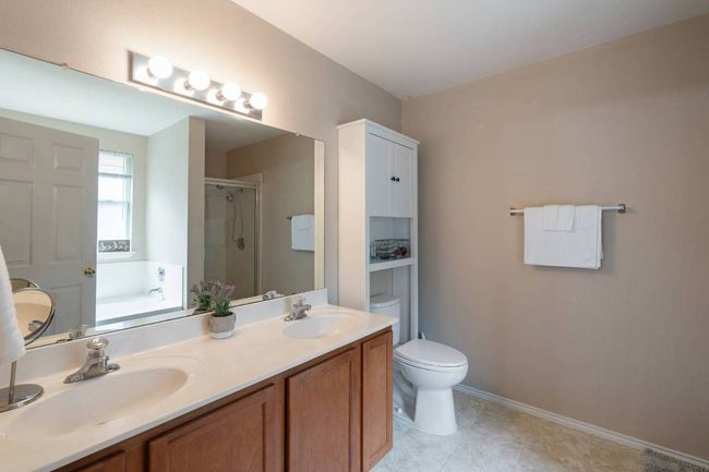 Full bath with a garden tub, a shower stall, double vanity, and tile patterned floors | Image 18
