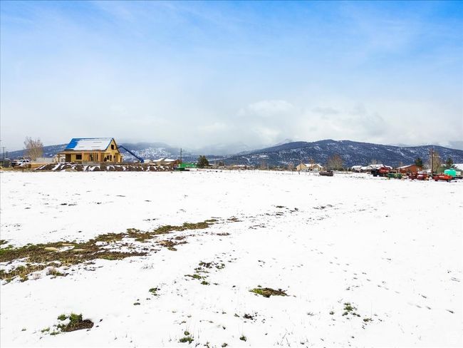 Yard covered in snow featuring a mountain view | Image 14