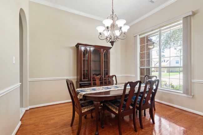 Just off the foyer is the formal dining room boasting chair rail and crown molding | Image 9