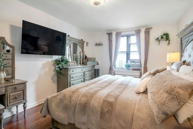 Bedroom featuring dark wood-style floors and cooling unit | Image 13
