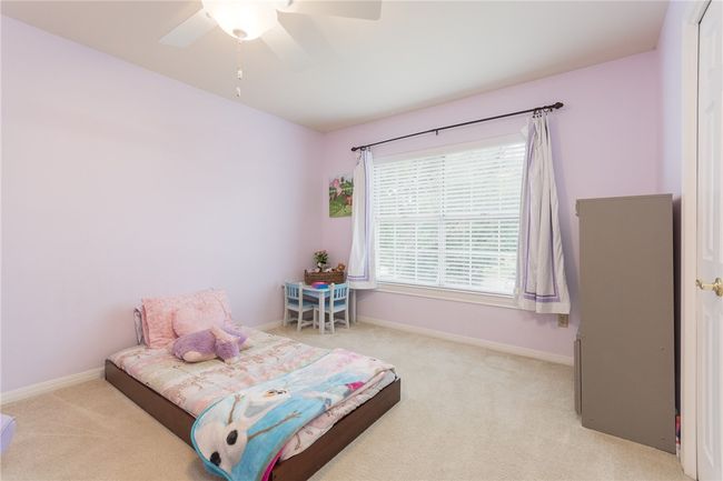 Carpeted bedroom featuring baseboards and a ceiling fan | Image 19