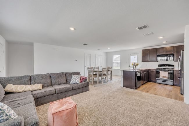Living room with light colored carpet and recessed lighting | Image 11