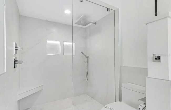 Gorgeous glassed-in standing shower with rain head shower | Image 27