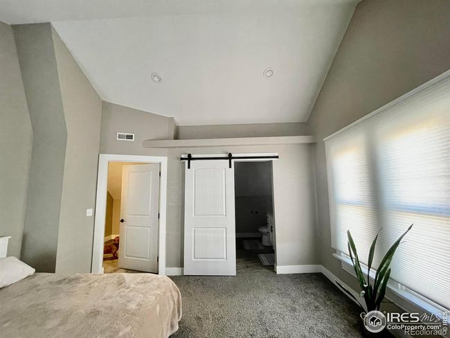 Nice ledge with vaulted ceiling barn door leads to bathroom | Image 21