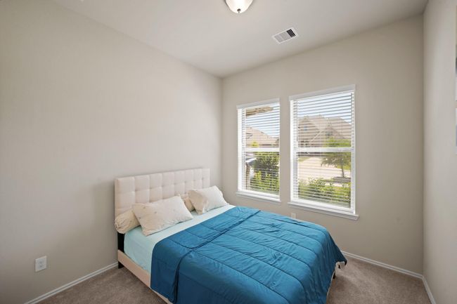 Third bedroom features largewindows and plush carpet. | Image 28