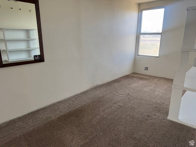 Spare room featuring a wealth of natural light and carpet flooring | Image 33