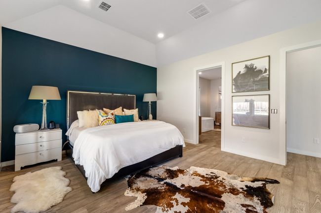 Bedroom featuring vaulted ceiling and wood finished floors | Image 21