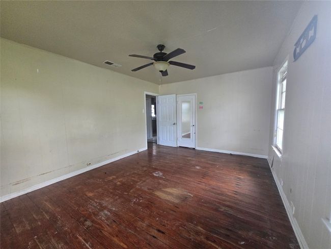 Spare room featuring hardwood / wood-style flooring, ceiling fan, and baseboards | Image 8