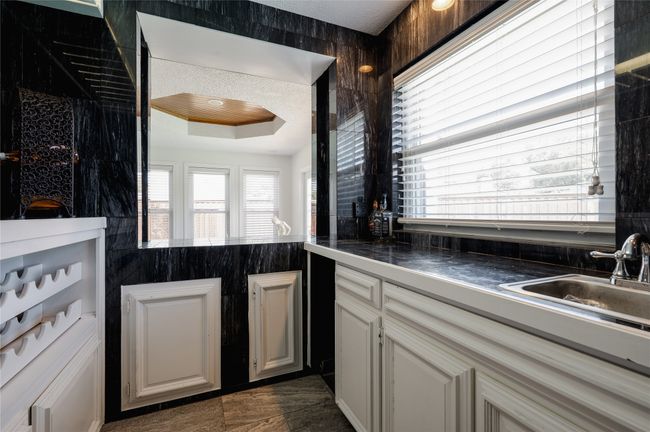 Kitchen with a raised ceiling and a sink | Image 12