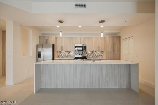 Kitchen featuring baseboards, stainless steel appliances, visible vents, and a sink | Image 6