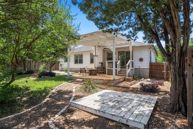 Rear view of property with a deck, a pergola, and a fenced backyard | Image 4