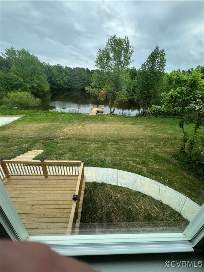View of yard with a deck with water view and a forest view | Image 17