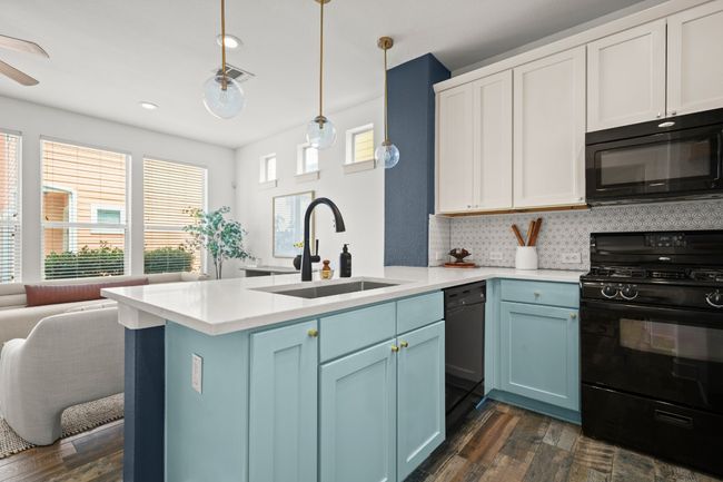 Kitchen featuring black appliances, a sink, dark wood-style floors, blue cabinetry, and recessed lighting | Image 19