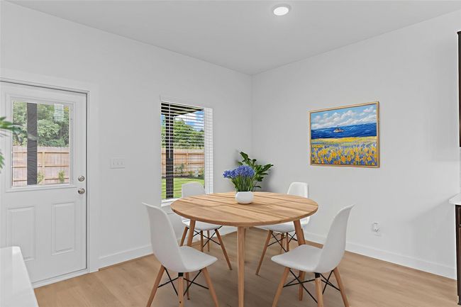 Bright and welcoming breakfast area nestled between the kitchen and backyard, featuring large windows that bring in natural light—perfect for casual meals or a quiet morning coffee. *Virtually Staged Photo* **Image Representative of Plan Only and May Vary as Built**. | Image 11