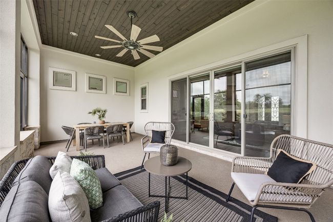 Sunroom featuring outdoor lounge area, a ceiling fan, and outdoor dining space | Image 33