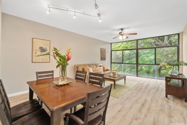 Open floor plan where dining area blends seamlessly with the living room. Notice the wall of windows which allows tons of sunlight in. | Image 4