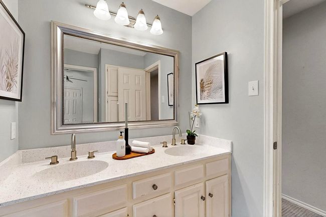 Bathroom with double vanity and baseboards | Image 31