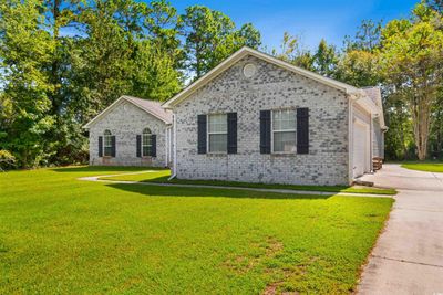 View of front of property featuring a garage and a front yard | Image 2