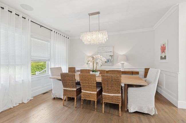 Dining room with a chandelier, ornamental molding, wood finished floors, and wainscoting | Image 4