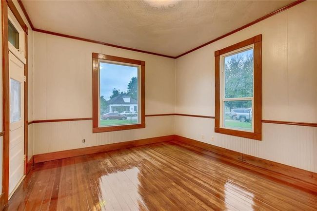 Unfurnished room featuring wood-type flooring, ornamental molding, and baseboards | Image 19