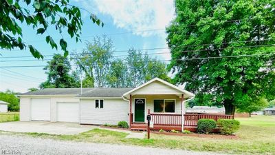 View of front of property with a deck and a front lawn | Image 1