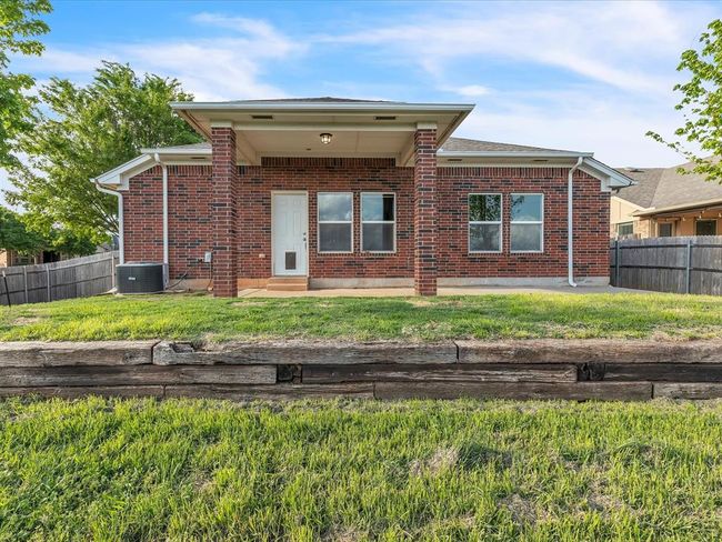 Rear view of property with central AC, brick siding, fence, and a patio | Image 18