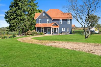 house featuring a yard | Image 1