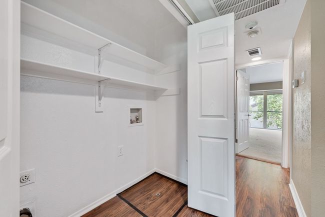 Laundry area featuring laundry area, wood finished floors, hookup for a washing machine, and visible vents | Image 19