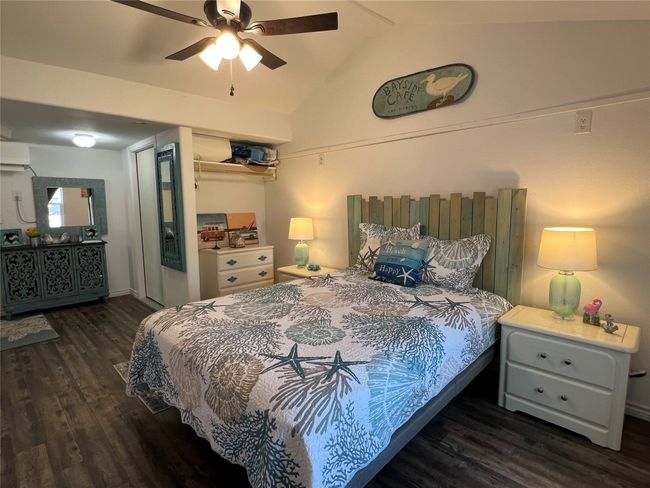 Bedroom featuring a ceiling fan, lofted ceiling, and wood finished floors | Image 21