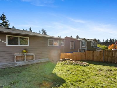 Fenced Front Yard off the paved Driveway & Carport - leads around Back to fenced Backyard. | Image 2