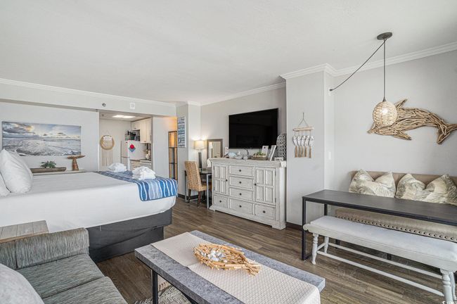 Bedroom featuring crown molding, wood finished floors, and freestanding refrigerator | Image 9