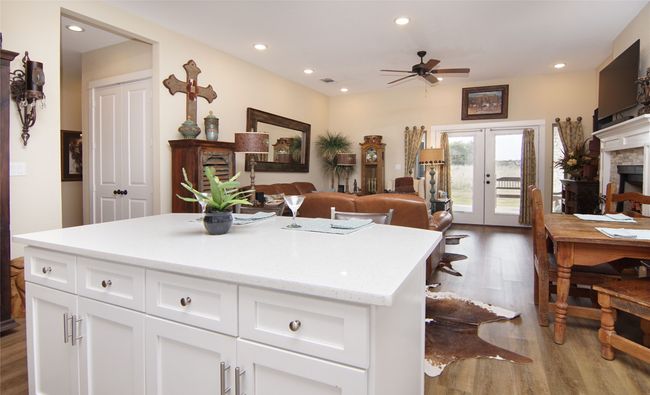 Kitchen featuring wood finished floors, ceiling fan, recessed lighting, french doors, and white cabinets | Image 13