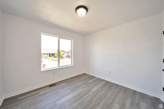 Primary bedroom with LVP flooring | Image 15