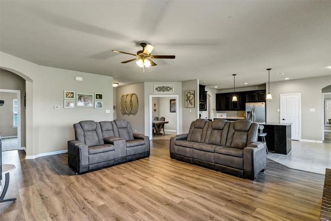 Living room with ceiling fan and light wood-type flooring | Image 8