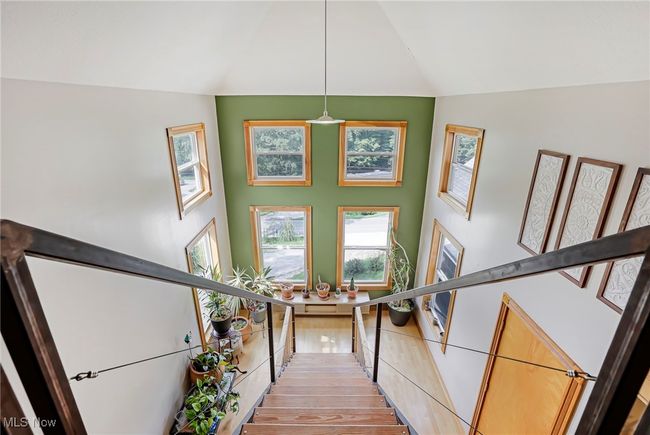 Stairway featuring a towering ceiling and wood finished floors | Image 21