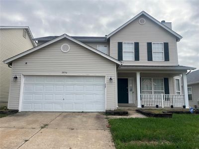 View of front of house featuring a garage and a porch | Image 1