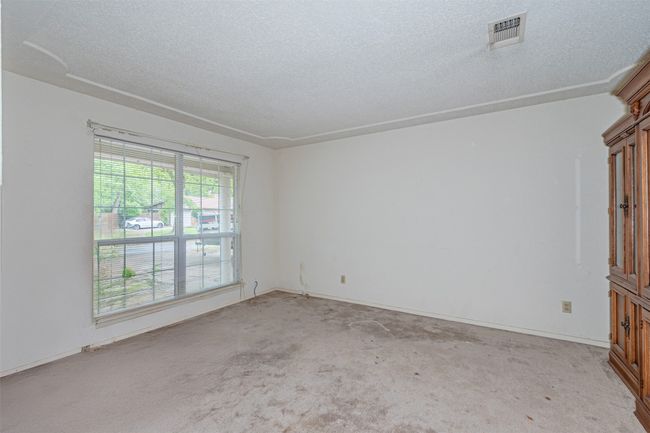 Spare room with a textured ceiling, visible vents, and carpet | Image 6