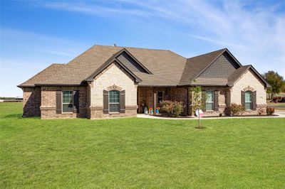 French country home featuring a front lawn | Image 1