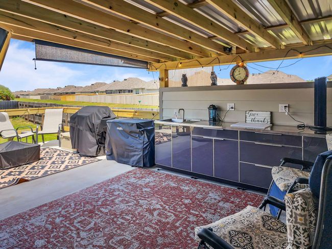 View of patio with grilling area and a residential view | Image 28