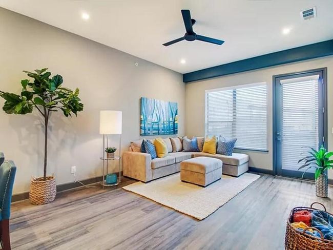 Living room featuring visible vents, ceiling fan, baseboards, and wood finished floors | Image 11