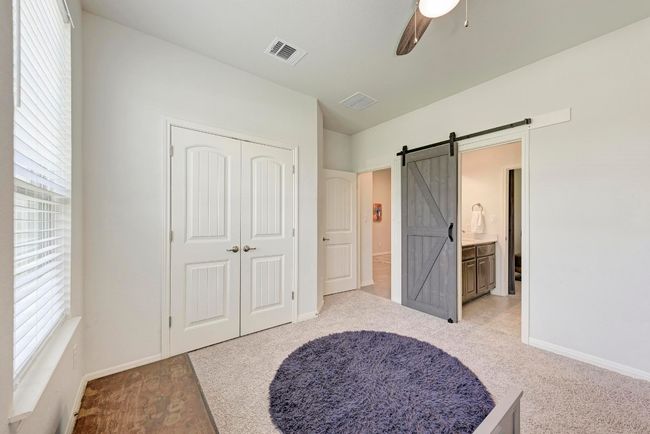 Both entrances to the shared Hollywood-style bath feature farmhouse-style sliding doors. | Image 31