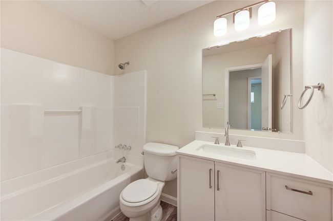 Secondary bath. All bathrooms have new vanity cabinets with counters, new sinks and faucets, new mirrors and light fixtures and new towel bars and cabinet hardware! | Image 15