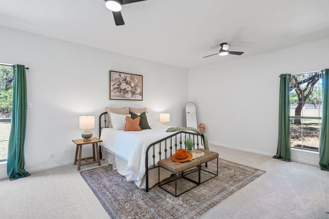 Bedroom featuring carpet floors, ceiling fan, and multiple windows | Image 15
