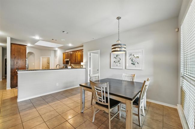 Dining room featuring light tile patterned flooring, arched walkways, and recessed lighting | Image 25